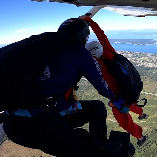 Skydiving coach releasing student for a static line skydive