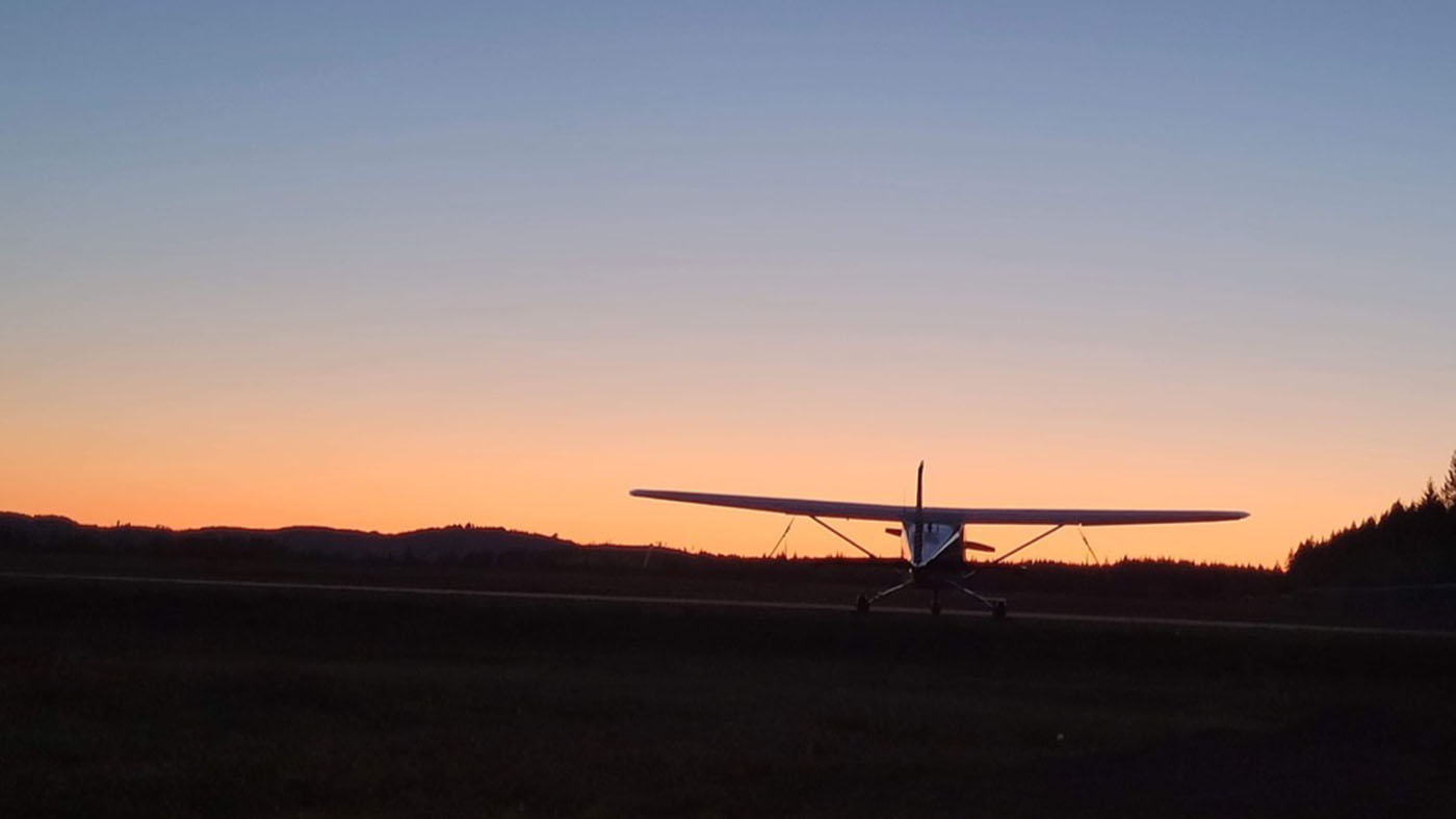 Sunset with silhouette of a plane